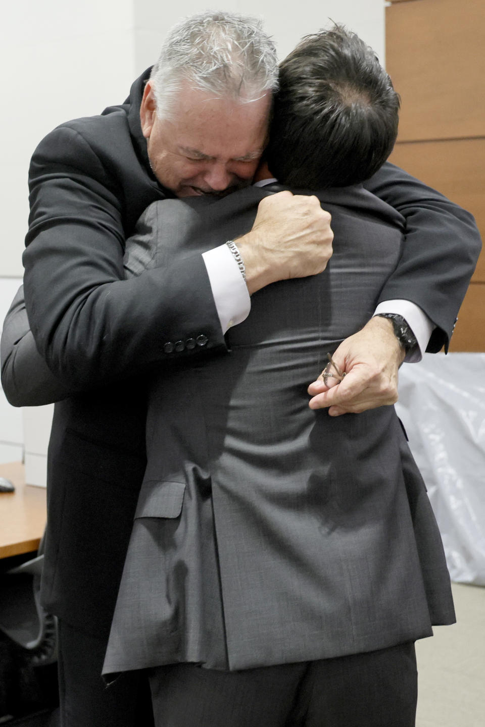 Former Marjory Stoneman Douglas High School School Resource Officer Scot Peterson, left, hugs his defense attorney, Mark Eiglarsh, after being found not guilty on all charges at the Broward County Courthouse in Fort Lauderdale, Fla., on Thursday, June 29, 2023. Peterson was acquitted of child neglect and other charges for failing to act during the Parkland school massacre, where 14 students and three staff members were murdered. (Amy Beth Bennett/South Florida Sun-Sentinel via AP, Pool)