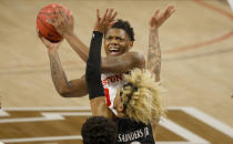 Houston guard Marcus Sasser (0) goes inside to shoot as Cincinnati guard Mike Saunders (3) defends during the first half of an NCAA college basketball game in the final round of the American Athletic Conference men's tournament Sunday, March 14, 2021, in Fort Worth, Texas. (AP Photo/Ron Jenkins)