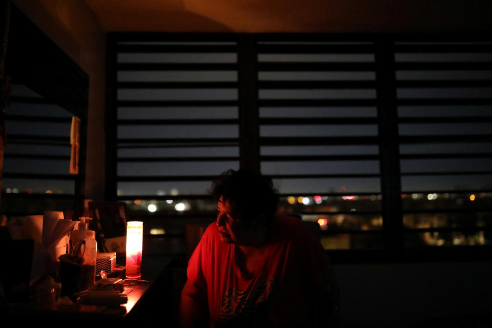 Carmen Correa uses a candle to light up a room at the Moradas Las Teresas Elderly House, where about two hundred elderly people live without electricity following damages caused by Hurricane Maria in Carolina, Puerto Rico, September 30, 2017. (Photo: Carlos Barria / Reuters)