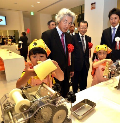 Children make instant noodles, while former Japanese prime minister Junichiro Koizumi (centre) looks on at the opening of a cup noodle museum in Yokohama, suburban Tokyo, on September 17. Japan's Nissin Foods has opened a cup noodle museum charting the history of the speedy snack where visitors even get the chance to create their own tasty version