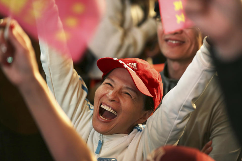 A supporter of Taiwan's 2020 presidential election candidate, Taiwan president Tsai Ing-wen cheers for Tsai's victory in Taipei, Taiwan, Saturday, Jan. 11, 2020. (AP Photo/Chiang Ying-ying)