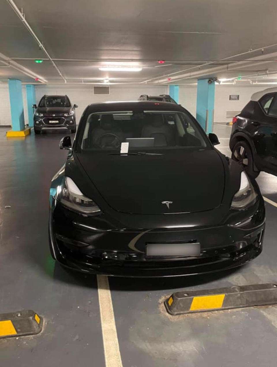 The Tesla poked slightly over the border of the car park it was occupying in Bondi. Source: Facebook