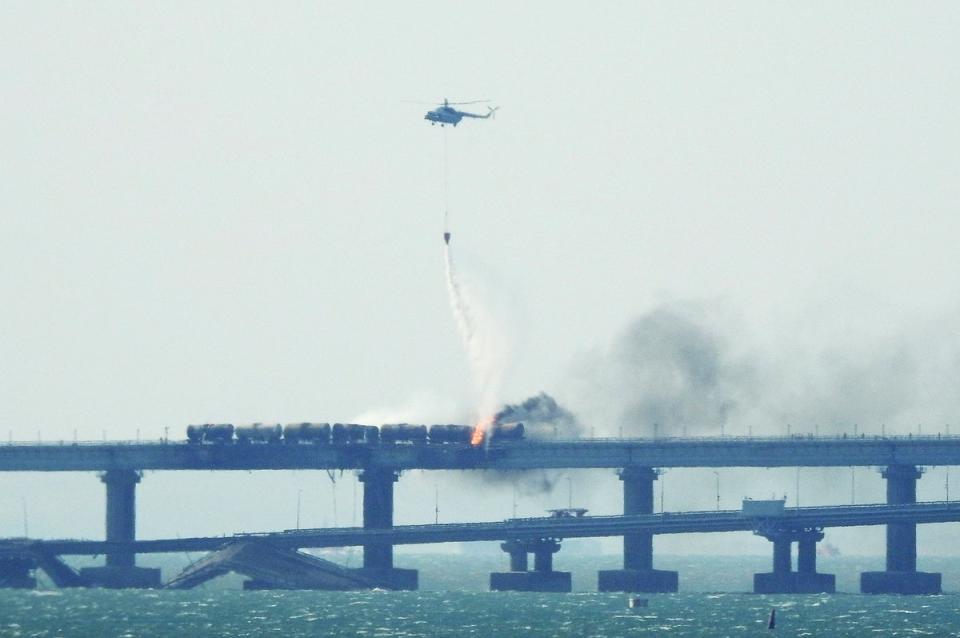 Helicopters poured water on the fire to tackle the roaring flames (AFP via Getty Images)