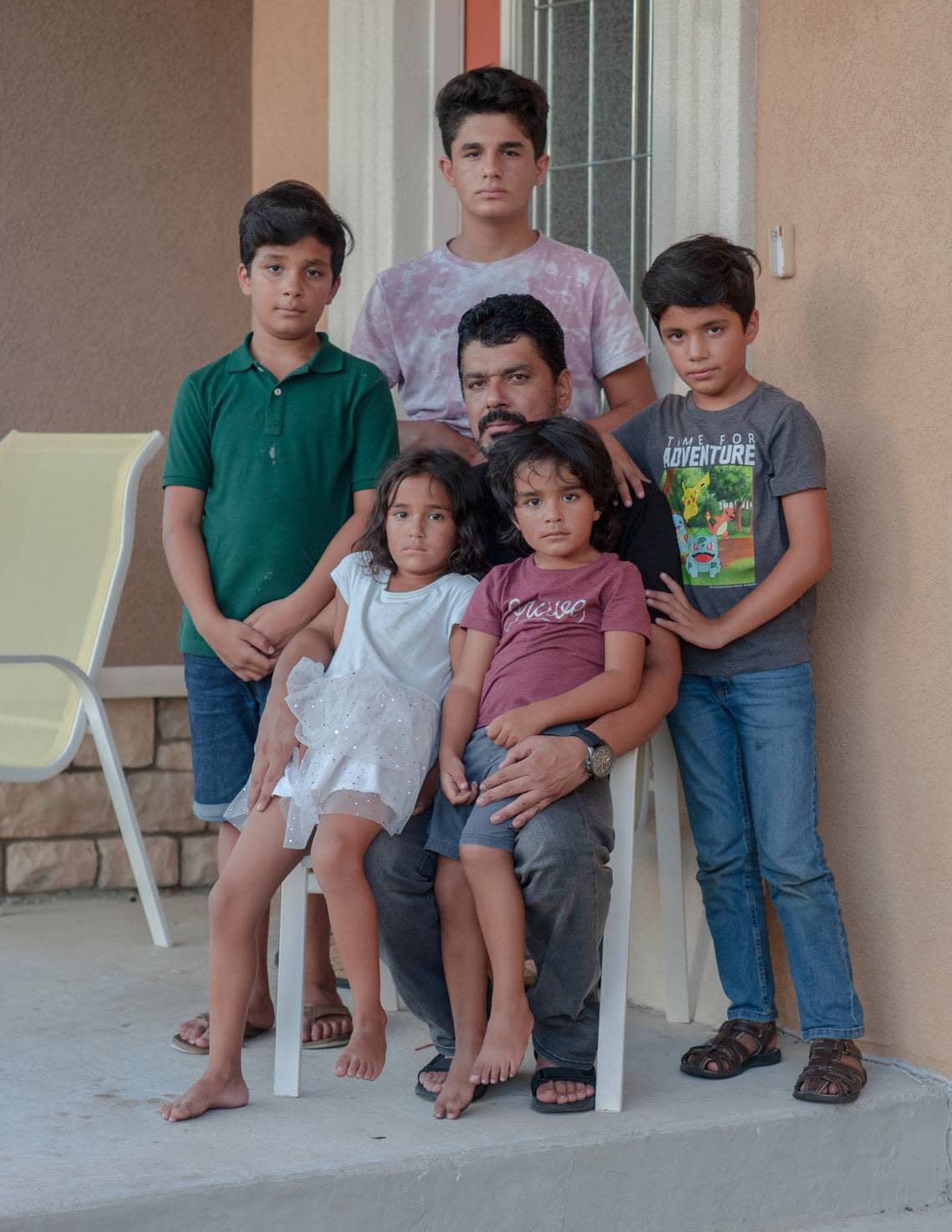 Rezwan’s father, Lemar, and the family’s other children at their home in Missouri.