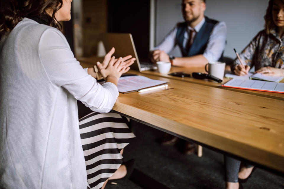 Interview in a board room between 2 job recruiters and a candidate