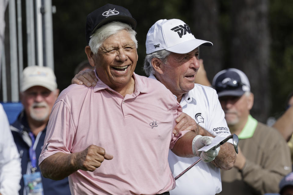 Lee Travino, left, and Gary Player, right, joke around on the first tee during the first round of the PNC Championship golf tournament Saturday, Dec. 17, 2022, in Orlando, Fla. (AP Photo/Kevin Kolczynski)