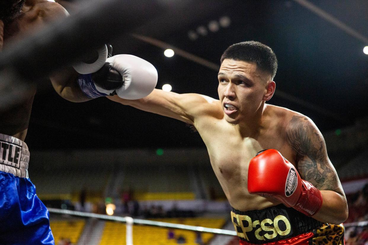 Jorge Tovar, red gloves, and Tavorua Teague blue gloves, compete in the main event during the School of Hard Knocks boxing match at Pan American Center on Friday, Aug. 12, 2022. 