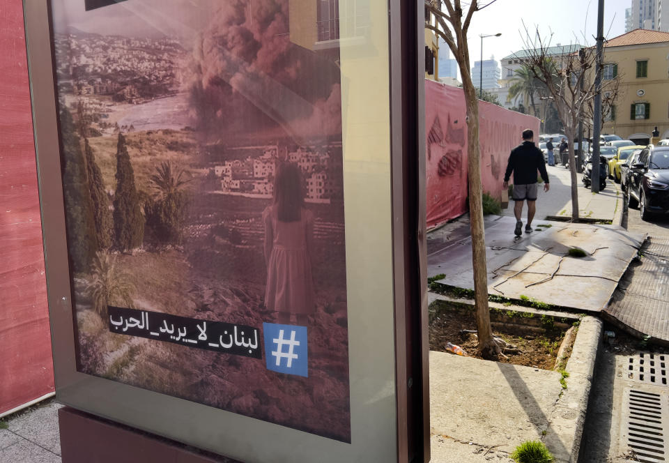 An anti-war advertising poster with Arabic words that read: Lebanon doesn't want the war," appears on a street in downtown Beirut, Lebanon, Tuesday, March 26, 2024. A war of words that has unfolded in Lebanon show longstanding schisms in the small country over Hezbollah, now amplified by the militant group's role in the Lebanon-Israel border clashes and by fears that an already crisis-hit Lebanon could be dragged into an all-out war.(AP Photo/Hussein Malla)