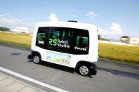 Robot Shuttle, a driver-less, self driving bus, developed by Japan's internet commerce and mobile games provider DeNA Co., drives past during an experimental trial with a self-driving bus in a community in Nishikata town, Tochigi Prefecture, Japan September 8, 2017. REUTERS/Issei Kato