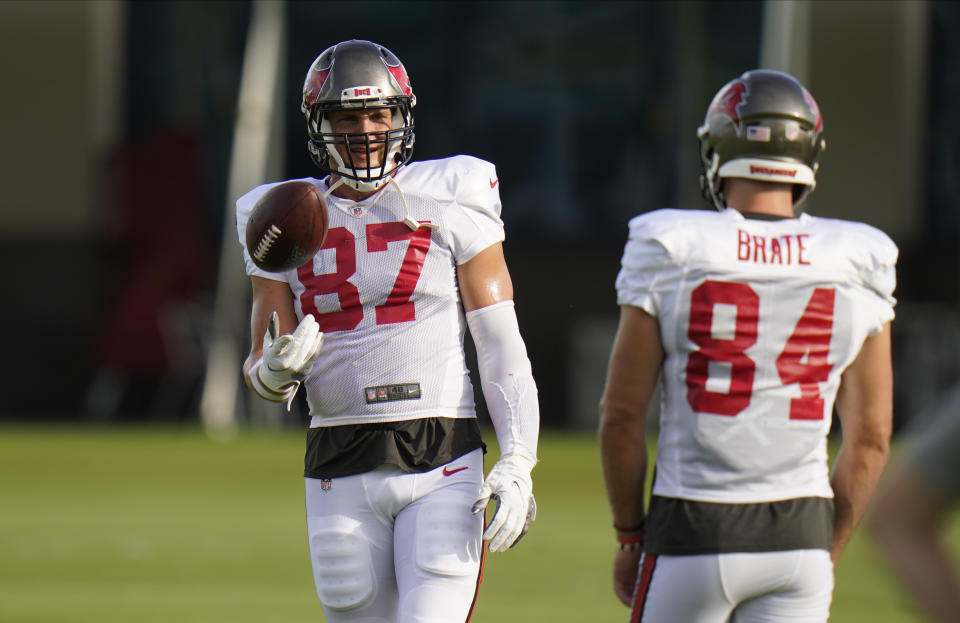 Tampa Bay Buccaneers tight end Rob Gronkowski (87) and tight end Cameron Brate (84) are shown during an NFL football training camp practice Tuesday, Aug. 18, 2020, in Tampa, Fla. A refreshed Rob Gronkowski is back on the practice field with Tom Brady, sweating in the hot Florida sun, preparing for their first season with the Tampa Bay Buccaneers. And, he is loving every minute of it. (AP Photo/Chris O'Meara)