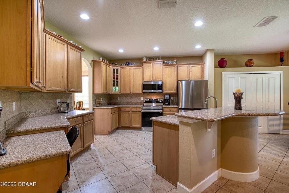 The spacious and open kitchen features new stainless-steel appliances, lots of counter space, an extended breakfast bar, large pantry and a breakfast nook.