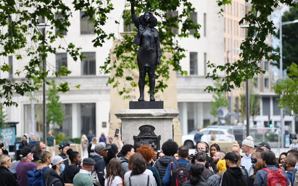 People gather to view the sculpture, by local artist Marc Quinn - Getty Images Europe 