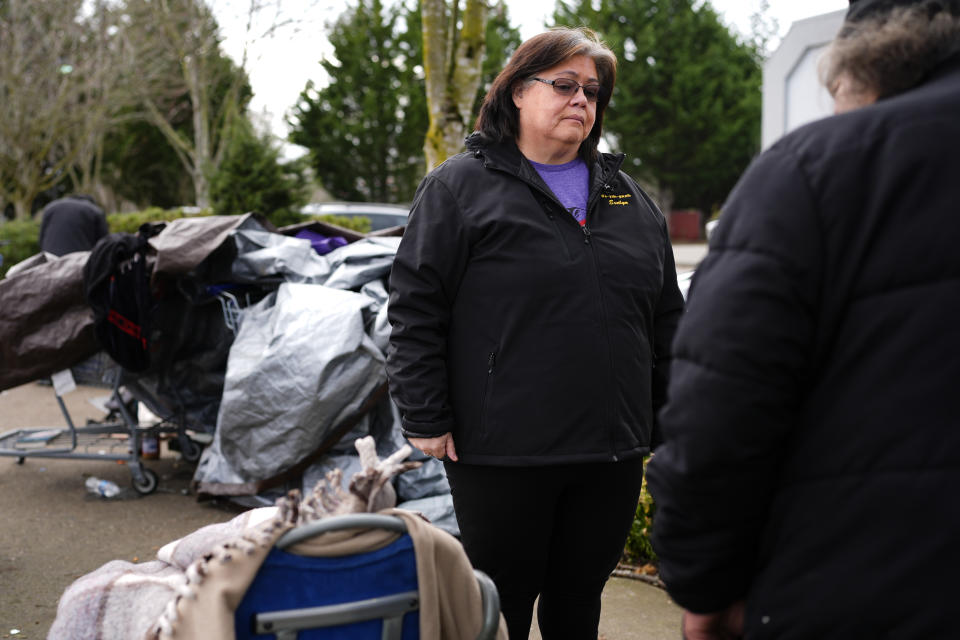 Evelyn Jefferson, a crisis outreach supervisor for Lummi Nation, talks with Rodney Julius, 60, who lives on the street and has used fentanyl, Thursday, Feb. 8, 2024, in Bellingham, Wash. Jefferson's own son died last fall due to an overdose of street drugs containing the synthetic opioid carfentanil, which he bought while having to wait to access Suboxone, a medicine to treat dependence on opioids. (AP Photo/Lindsey Wasson)