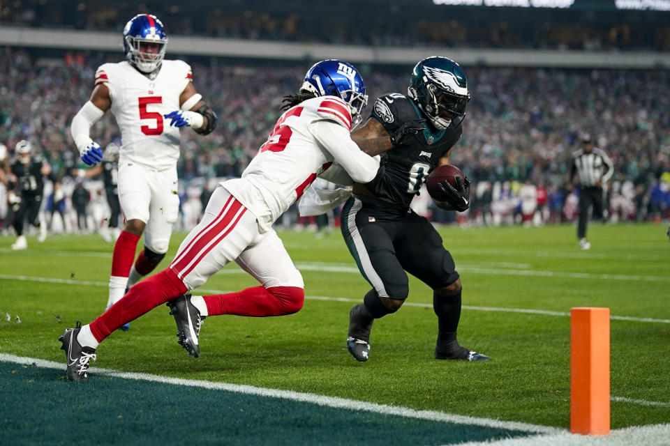 Philadelphia Eagles running back D'Andre Swift is tackled by New York Giants cornerback Deonte Banks during the first half of an NFL football game Monday, Dec. 25, 2023, in Philadelphia. (AP Photo/Matt Slocum)