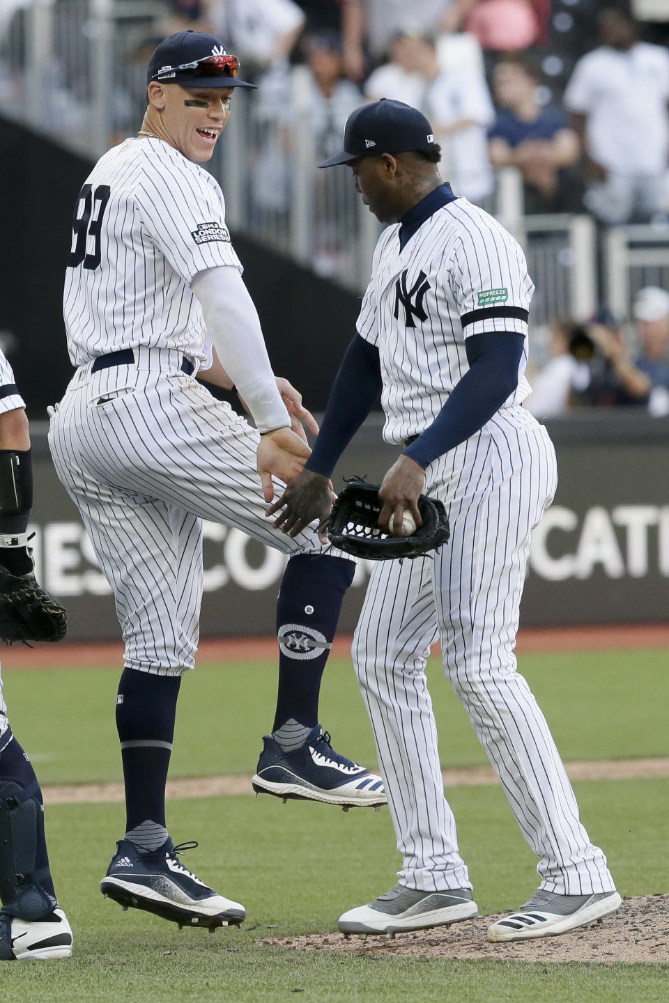 New York Yankees right fielder Aaron Judge, left, and relief pitcher Aroldis Chapman celebrate after their 12-8 win during a baseball game in London, Sunday, June 30, 2019. (AP Photo/Tim Ireland)