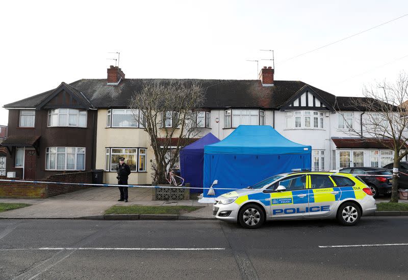 Police stand on duty outside the home of Nikolai Glushkov in New Malden, on the outskirts of London