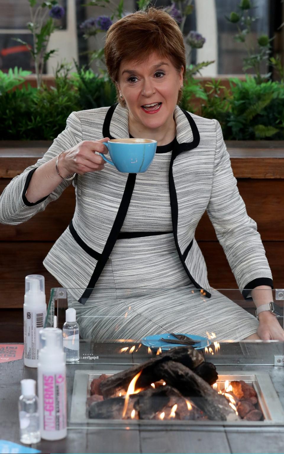 Nicola Sturgeon visited a beer garden - where she enjoyed a coffee - ahead of pubs reopening - Pool/Getty