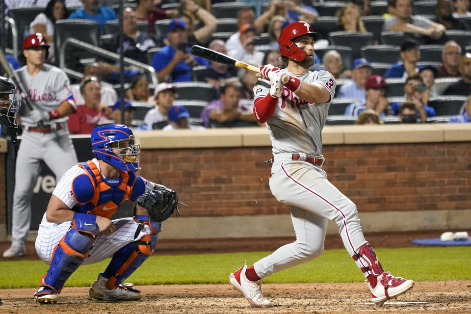 Philadelphia Phillies' Bryce Harper follows through on an RBI-double during the seventh inning of a baseball game against the New York Mets, Saturday, Sept. 18, 2021, in New York. (AP Photo/Mary Altaffer)