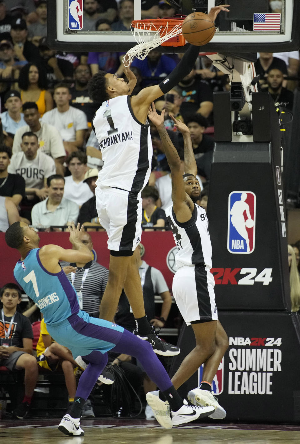 San Antonio Spurs' Victor Wembanyama (1) blocks a shot by Charlotte Hornets' Bryce McGowens, left, during the first half of an NBA summer league basketball game Friday, July 7, 2023, in Las Vegas. (AP Photo/John Locher)