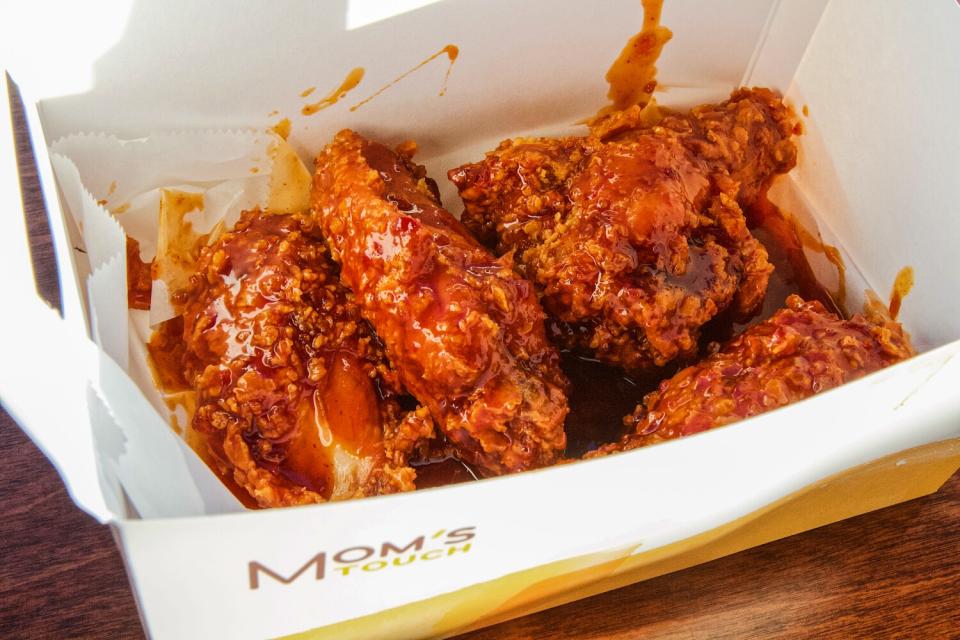 A box full of saucy chicken wings from Mom's Touch.