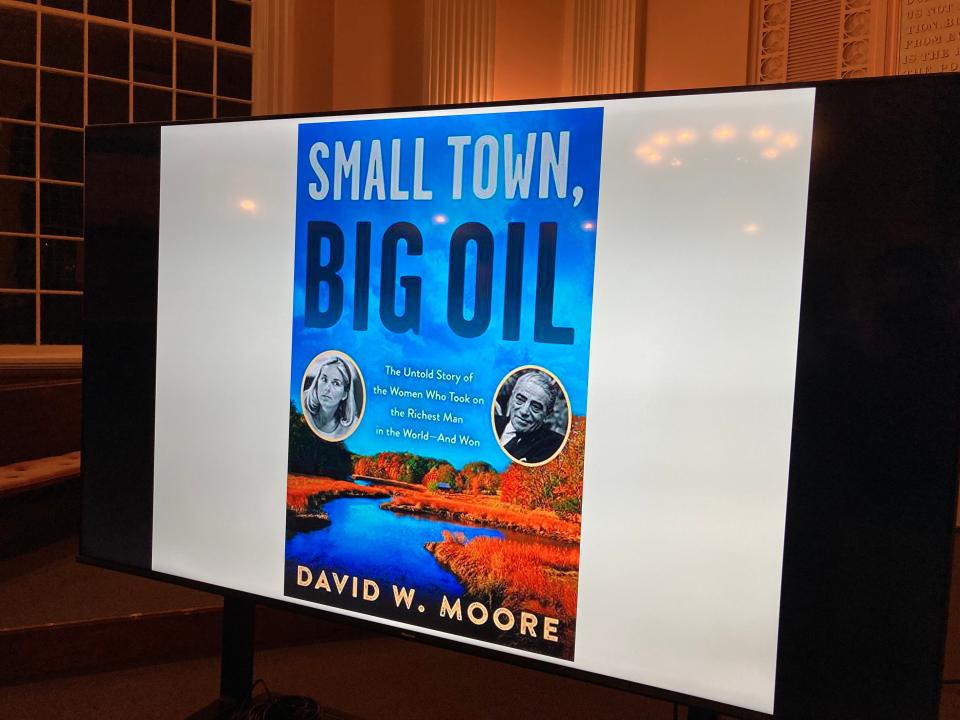 A projection of the cover of "Small Town, Big Oil," seen in Portsmouth on Thursday, May 5. The book, written by David Moore, details how three women, including former Durham state representative Dudley Dudley, prevented a $600 million oil refinery from being built in Durham almost 50 years ago.