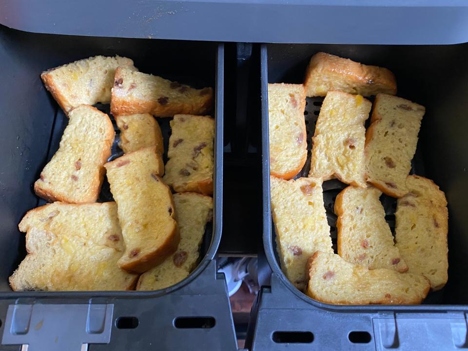 french toast sticks lined up in air fryer basket