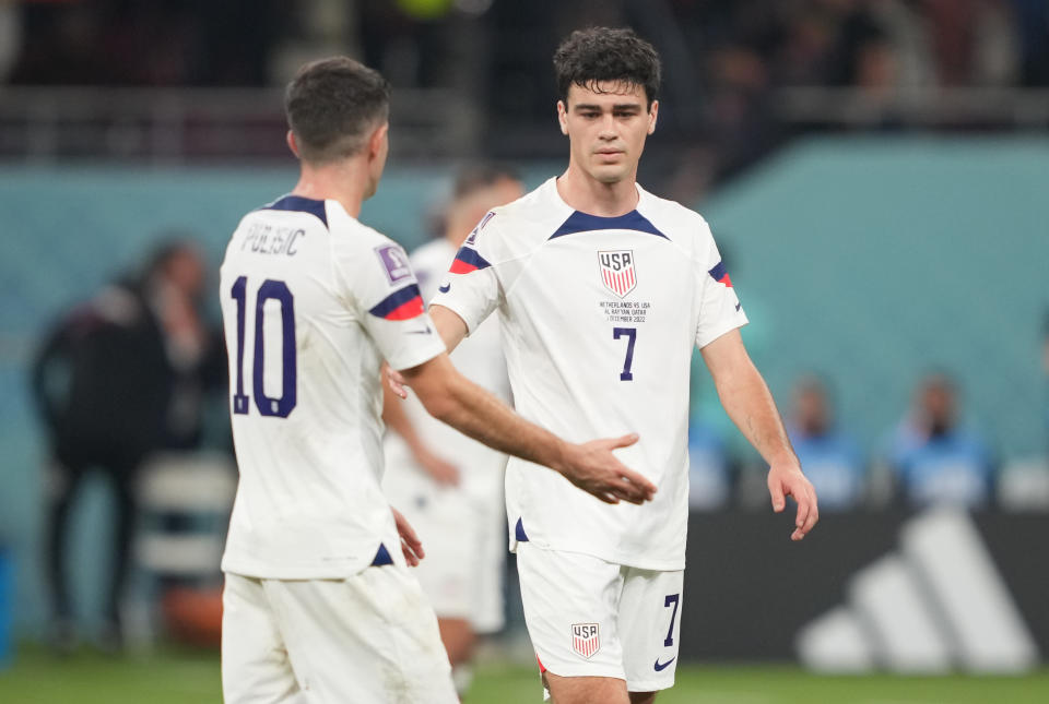 DOHA, QATAR - DECEMBER 3: Christian Pulisic #10 and Gio Reyna #7of the United States find solis with one another after their loss to the Netherlands after a FIFA World Cup Qatar 2022 Round of 16 match between Netherlands and USMNT at Khalifa International Stadium on December 3, 2022 in Doha, Qatar. (Photo by John Todd/ISI Photos/Getty Images)