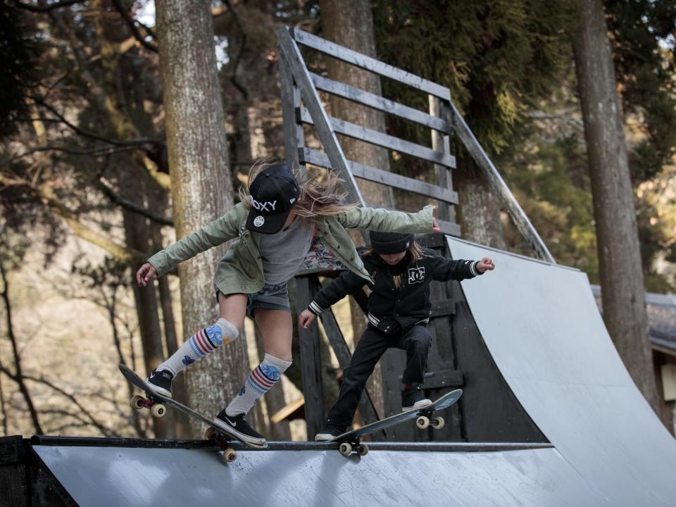 Sky Brown (L) and her brother Ocean (R) show their skateboarding skills on the half-pipe at a park in Kijo town, Miyazaki in 2018.