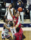 Connecticut guard Tyrese Martin (4) shoots against St. John's guard Julian Champagnie (2) in the second half of an NCAA college basketball game in Storrs, Conn., Monday, Jan. 18, 2021. (David Butler II/Pool Photo via AP)