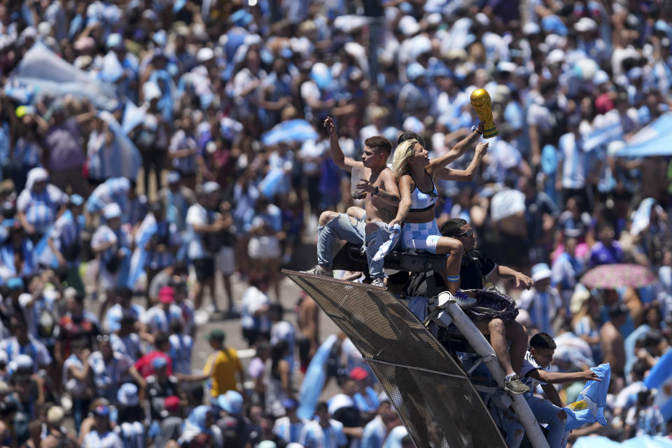 Soccer fans welcome home the Argentine soccer team after it won the World Cup title, in Buenos Aires, Argentina, Tuesday, Dec. 20, 2022. (AP Photo/Matilde Campodonico)