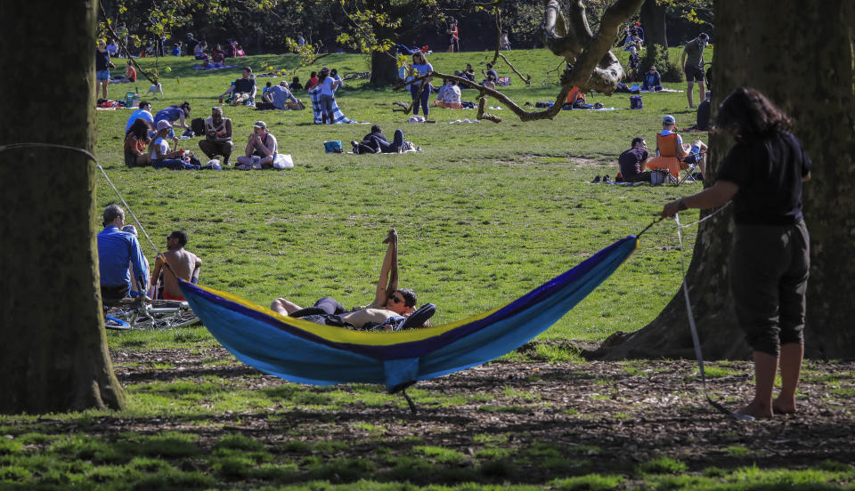 People leave home for the outdoors as the temperature hovered around 70 degrees, even as the stay-at-home order remained in effect with Governor Andrew Cuomo warning that any change in behavior could reignite the spread of coronavirus, Saturday, May 2, 2020, in Brooklyn's Prospect Park in New York. (AP Photo/Bebeto Matthews)