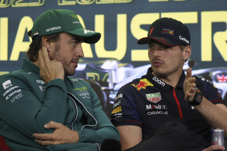 Aston Martin driver Fernando Alonso of Spain, left, and Red Bull driver Max Verstappen of Netherlands chat during a press conference ahead of the Australian Formula One Grand Prix at Albert Park in Melbourne, Thursday, March 30, 2023. (AP Photo/Asanka Brendon Ratnayake)