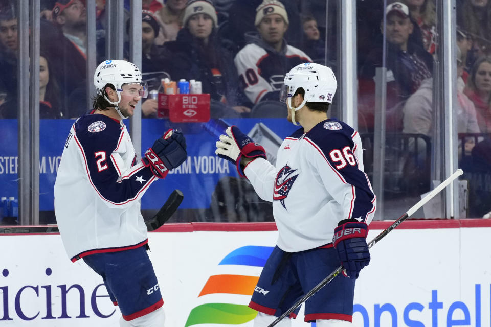 Columbus Blue Jackets' Andrew Peeke, left, and Jack Roslovic celebrate after Peeke's goal during the third period of an NHL hockey game against the Philadelphia Flyers, Tuesday, Dec. 20, 2022, in Philadelphia. (AP Photo/Matt Slocum)