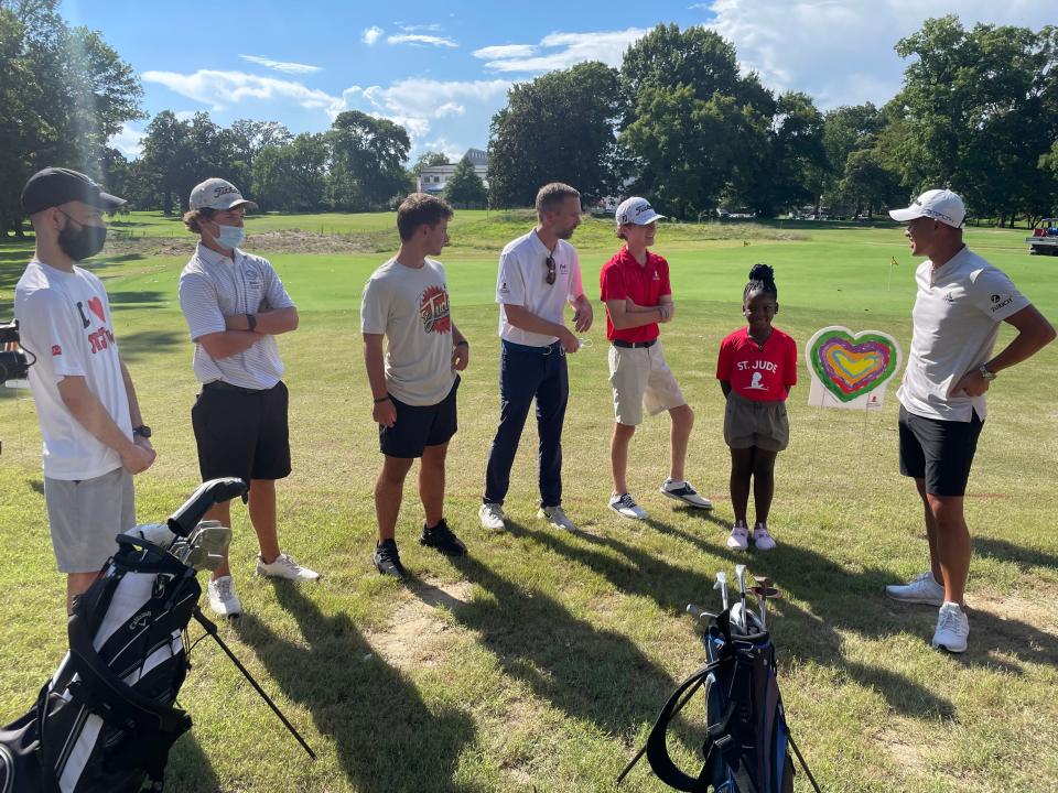 PGA Tour star Collin Morikawa (right) meets  with St. Jude Children's Research Hospital patients, including 16-year old Dakota Cunningham (second from left), during a golf clinic at the Overton Park 9 ahead of the 2022 FedEx St. Jude Championship.