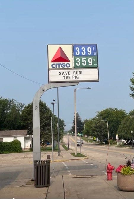 A sign at a Citgo gas station in Belleville, Wisconsin, 30 minutes from Madison, reads "Save Rudi the Pig."