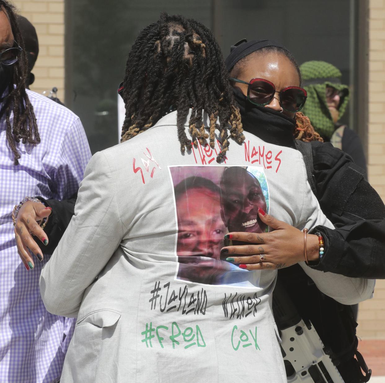 Michael Harris, left, is greeted as he arrives at the calling hours and funeral for Jayland Walker at the Civic Theatre on Wednesday, July 13, 2022 in Akron, Ohio.