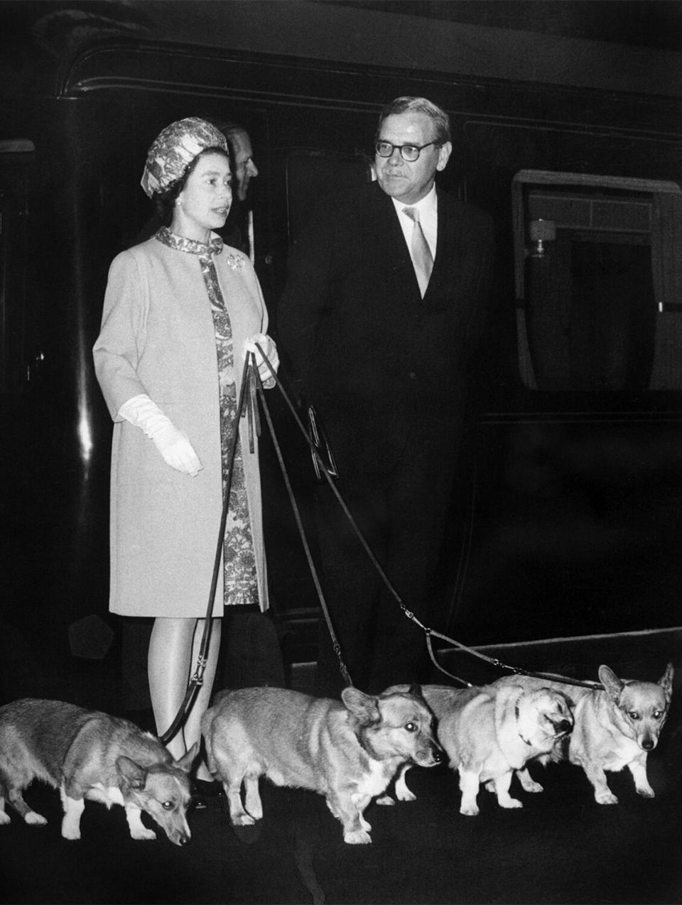 LONDON, UNITED KINGDOM - OCTOBER 15: Queen Elizabeth II arrives at King's Cross railway station in London 15 October 1969 with her four dogs of Corgis breed after holidays in Balmoral Castle in Scotland and before welcoming at Buckingham Palace US astronauts of Apollo 11 who walked on the Moon. (Photo credit should read STF/AFP via Getty Images)