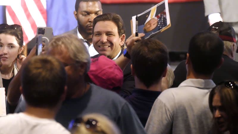 Gov. Ron DeSantis, R-Fla., smiles for photos as he signs books following remarks to a crowd at First Baptist North on Wednesday, April 19, 2023, in Spartanburg, S.C. 