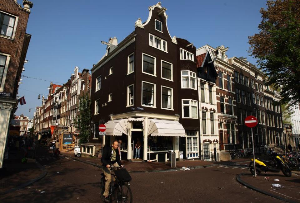 Cyclists make their way through the city streets in Amsterdam, Netherlands.