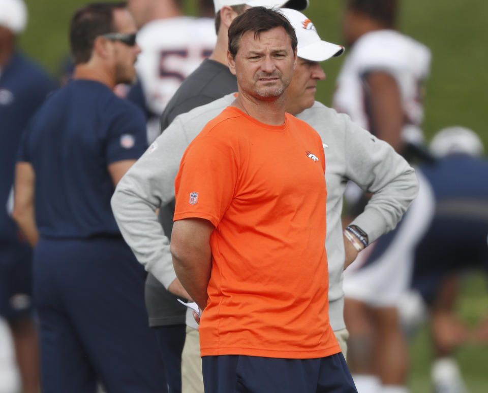 Denver Broncos offensive coordinator Rich Scangarello, front, and head coach Vic Fangio look on during a combined NFL football training camp with the San Francisco 49ers at the Broncos' headquarters Friday, Aug. 16, 2019, in Englewood, Colo. (AP Photo/David Zalubowski)