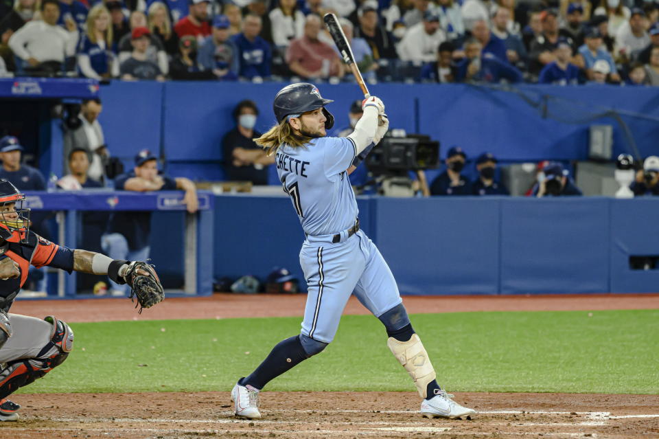 Toronto Blue Jays' Bo Bichette, right, watches his home run against the Houston Astros during the sixth inning of a baseball game in Toronto, Sunday, May 1, 2022. (Christopher Katsarov/The Canadian Press via AP)