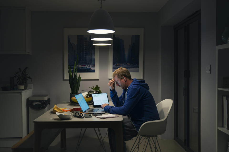 A stressed mature man looks through his home finances and bills - Cost of Living crisis