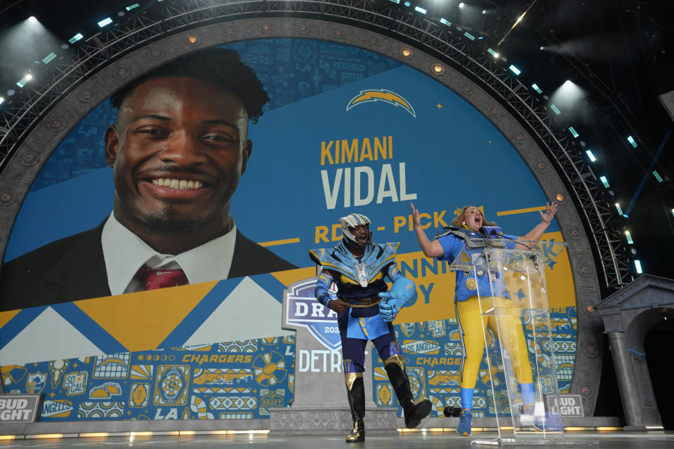 Fans react on stage during a pick announcement by the Los Angeles Chargers during the third day of the NFL football draft, Saturday, April 27, 2024, in Detroit. (AP Photo/Paul Sancya)