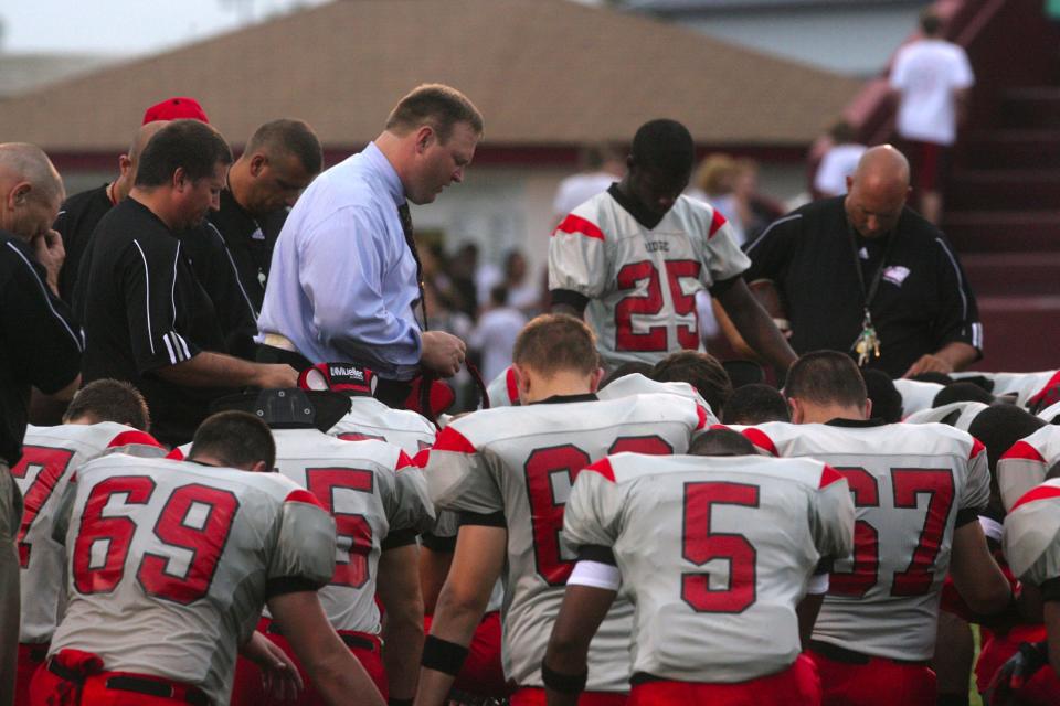 PRP coach, Jason Stinson prayed with the team before the game.  Ballard vs. PRP at Ballard._(Michael Hayman, The Courier-Journal)_September 5, 2008