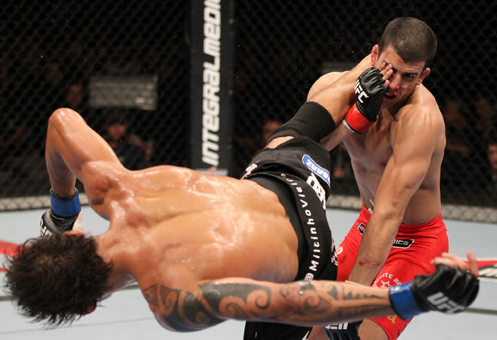 BELO HORIZONTE, BRAZIL - JUNE 23: (L-R) Milton Vieira delivers a spinning kick to the head of Felipe Arantes during their UFC 147 featherweight bout at Estadio Jornalista Felipe Drummond on June 23, 2012 in Belo Horizonte, Brazil.