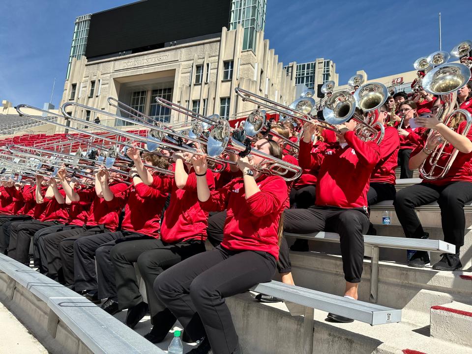 The Marching Hundred warms up at Memorial Stadium on Monday, April 8, 2024.
