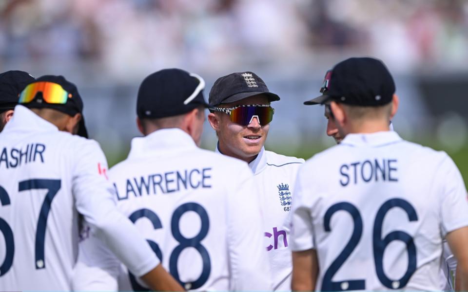 Ollie Pope leads England onto the field.