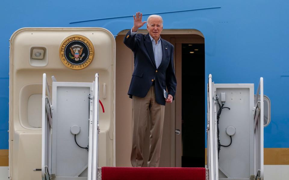 The president waving from the door of Air Force One - Jess Rapfogel/AP