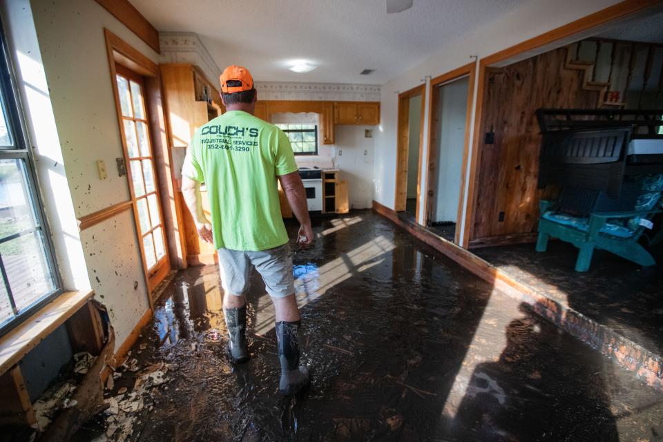 Frank Couch walks in mud through the kitchen of his home in Suwannee, Fla. as he surveys the damages caused by Hurricane Idalia on Thursday, Aug. 31, 2023.