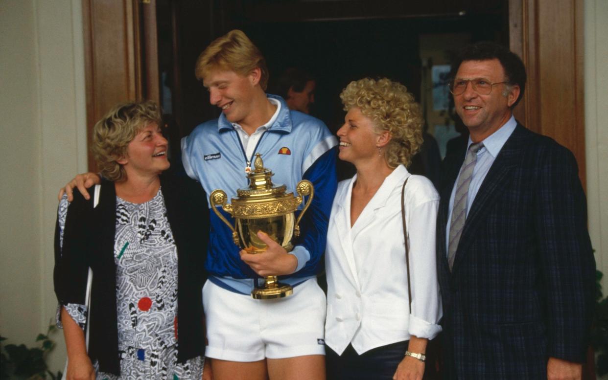 Becker holding the Gentlemen's Singles Challenge Cup Trophy with his mother Elvira, sister Sabine and father Karl-Heinz in 1986 - Popperfoto